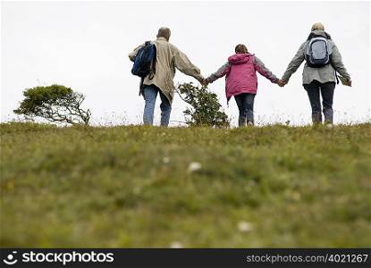 Seniors and granddaughter climb hill