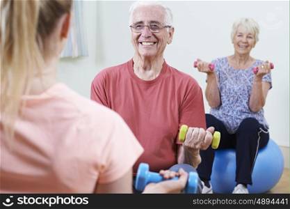 Seniors At Fitness Class With Instructor