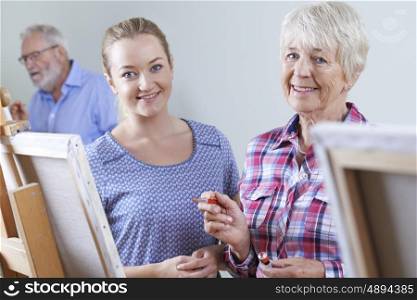 Seniors Attending Painting Class With Teacher