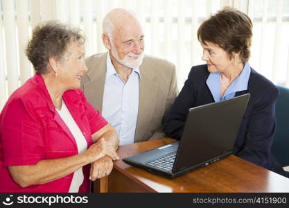 Seniors discuss their retirement with a financial advisor.