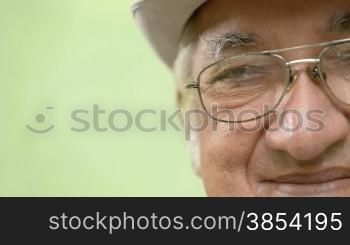 Seniors portrait of happy elderly man with white hat and glasses looking at camera. Sequence