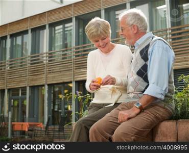 Seniors sitting on a wall