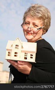 senoir woman with house model