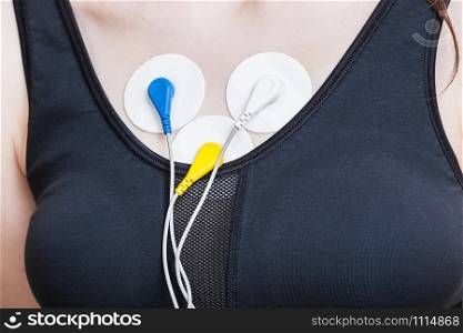 sensors of Holter monitoring of electrocardiogram are attached to girl&rsquo;s chest