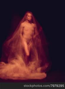 sensual and emotional dance of beautiful ballerina through the veil . mystical photo - a sensual and emotional dance of beautiful ballerina through the veil on a dark background. A stroboscopic image of the one model