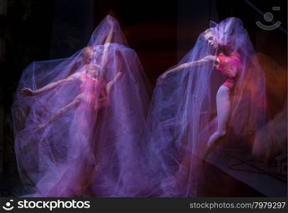 sensual and emotional dance of beautiful ballerina through the veil . photo as art - a sensual and emotional dance of beautiful ballerina through the veil on a dark background. A stroboscopic image of the one model