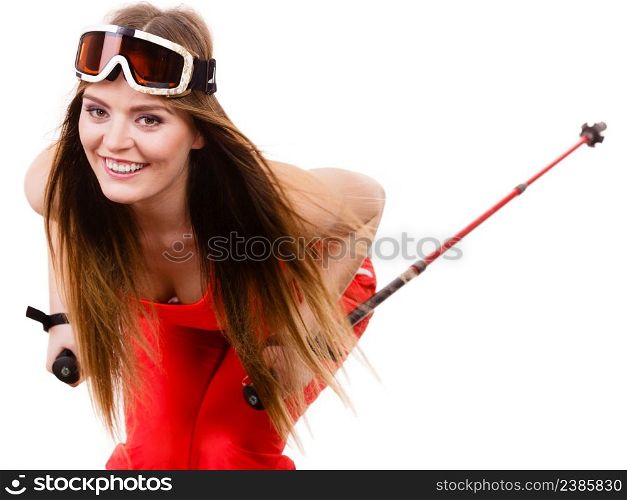Sensual attractive femine, winter sport, extreme hobby concept. Ready to ride woman wearing alluring ski suit and helmet with goggles, holding poles, studio shot on white background. Ready to ride woman wearing ski suit holding poles