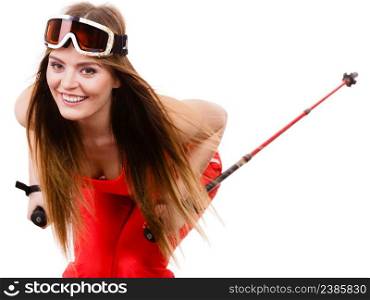 Sensual attractive femine, winter sport, extreme hobby concept. Ready to ride woman wearing alluring ski suit and helmet with goggles, holding poles, studio shot on white background. Ready to ride woman wearing ski suit holding poles