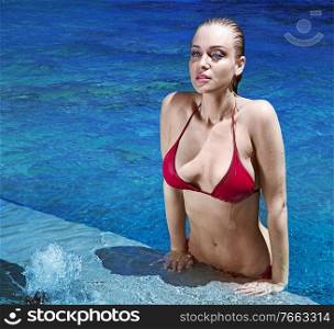 Sensual blond woman releaxing during swimming