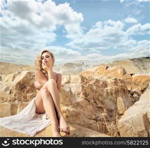 Sensual blond woman with the beautiful landscape behind