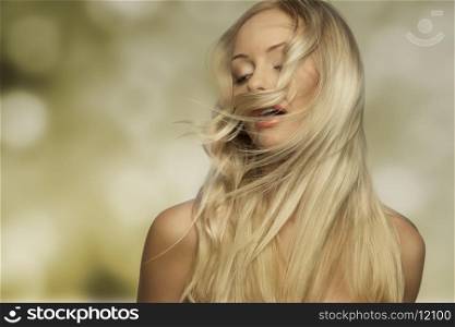 sensual blonde female with naked shoulders and flying smooth flying hair