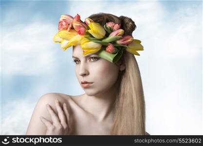 sensual blonde girl posing in spring portrait with perfect skin, long smooth hair, colorful make-up and floral wreath on her head