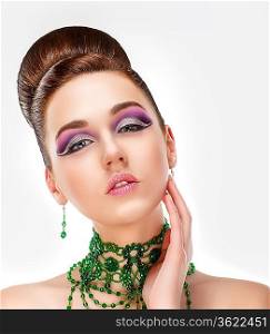 Sensual Brunette with Bright Purple Eye Make-up and Jewelry. Glamor