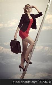 sensual business woman climbing ladder with sexy suit and work bag, looking in front of her with conviction