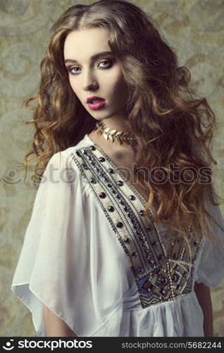 sensual curly girl wearing vintage dress, posing like a antique dame with jewellery and make-up