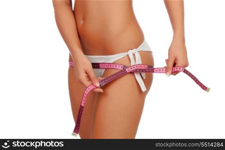 Sensual female body with bikini and tape measure isolated on a white background
