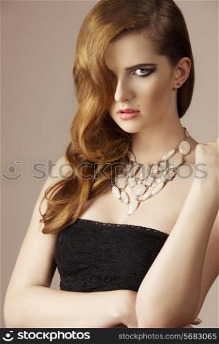sensual girl with long elegant wavy hair-style, cute necklace e dark dress. Perfect skin, fashion style