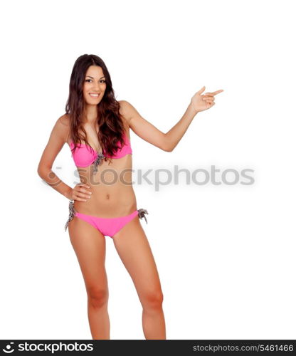 Sensual girl with pink bikini indicating something isolated on a white background