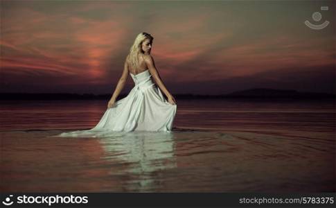Sensual lady dancing in the lake