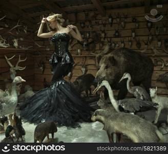 Sensual lady in a locked room full of wild animals
