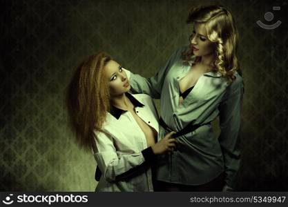 sensual old fashion portrait of two blonde women with open shirt, creative hair-style and cute make-up posing like a lesbians