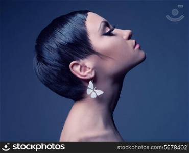 Sensual portrait of a beautiful lady with earring-butterfly