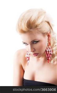 sensual portrait of very attractive blond woman with creative hair style and big fashion red earring with black top, she is turned of three quarters with a bent head and looks in front of her with an actractive expresison