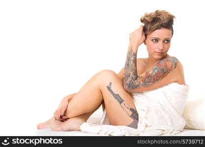 Sensual shot of a young tattooed woman in bed