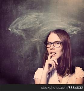 sensual student woman is standing with chalk board behind her