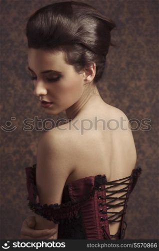 sensual sweet portrait of beauty woman in old fashion style , looking down and showing her shoulder