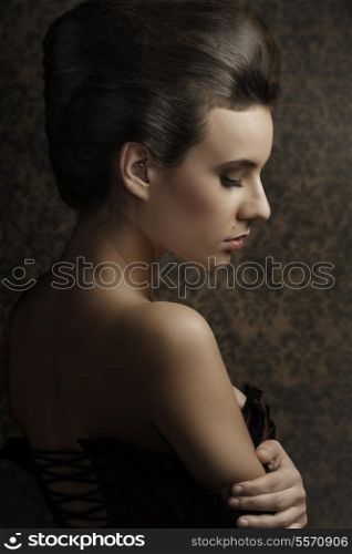 sensual sweet portrait of beauty woman in old fashion style , looking down and showing her shoulder