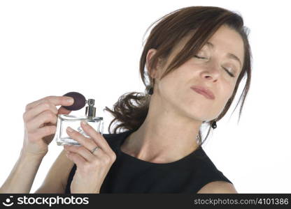 sensual woman applying perfume on her body