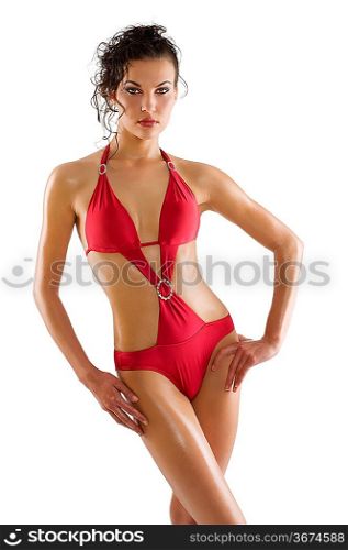 sensual woman brunette with sexy red swimsuit and hair style taking pose over white with wet skin