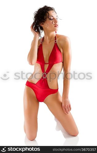 sensual woman brunette with sexy red swimsuit and hair style taking pose over white