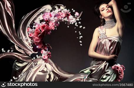 sensual woman in long light dress with flowers