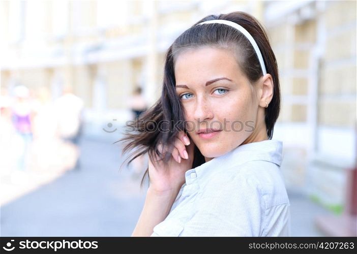 Sensual woman is looking back at sunny street