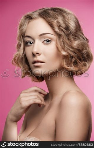 sensual woman posing in beauty portrait with short curly silky hair and natural make-up. Perfect skin