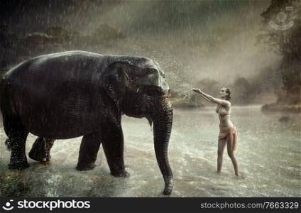 Sensual woman taming an indina elephant