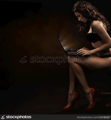 Sensual woman with laptop