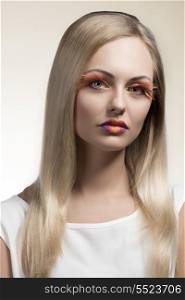 sensual woman with long smooth blonde hair, colorful and creative make-up, feathered eyelashes. Wearing white dress