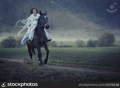 Sensual young beauty riding a horse