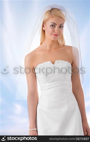 sensual young girl wearing wedding white dress, veil and pearls bracelet on celestial background