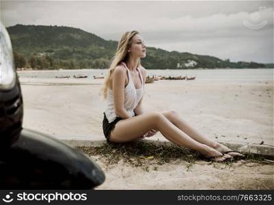 Sensual young woman enjoying summer on a tropical beach
