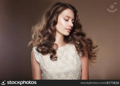 Sensual young woman with beautiful long brown flying hairs.