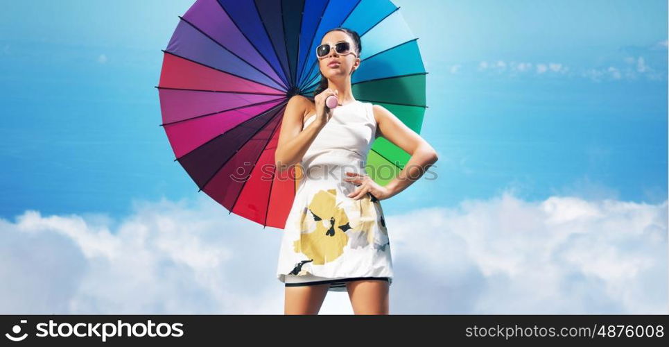 Sensual young woman with the colorful umbrella