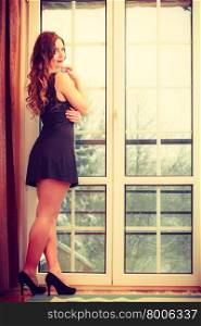 Sensuality and fashion. Young seductive sexy attractive woman in lingerie indoors french doors.