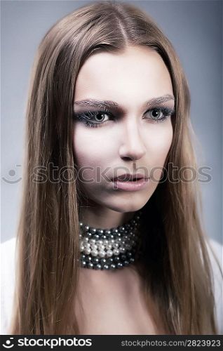 Sensuality. Attractive young fresh woman face with beauty long hair and necklace