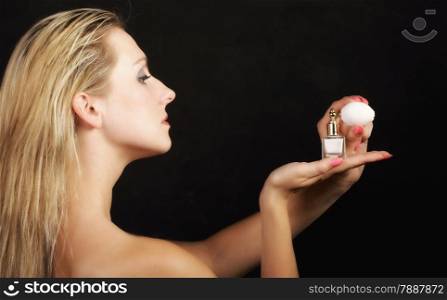 Sensuality concept. Portrait beautiful woman with perfume bottle on black background