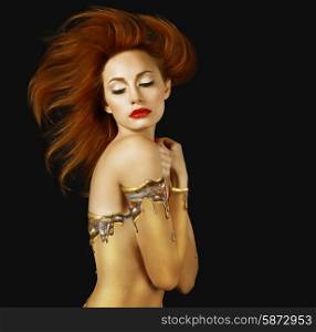 Sensuality. Red Hair Woman with Golden Skin