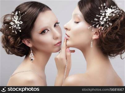 Sensuality. Two Women Fashion Models with Trendy Make-up